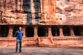 Man standing at ancient rock cut cave in the morning Royalty Free Stock Photo