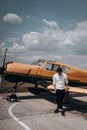 A man standing on the background of a small single engine plane. Royalty Free Stock Photo