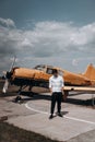 A man standing on the background of a small single engine plane. Royalty Free Stock Photo