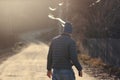 Man standing backward on a road