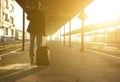 Man standing with bag and mobile phone at train station Royalty Free Stock Photo