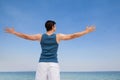 Man standing at beach with arms outstretched Royalty Free Stock Photo