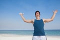 Man standing at beach with arms outstretched Royalty Free Stock Photo