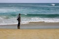 Man standing on a beach and looking at the ocean Royalty Free Stock Photo