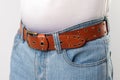 Man standing in blue jeans and brown leather handmade belt Royalty Free Stock Photo