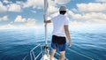 Man standing at the bow of a ship. Yachting, vacation and freedom concept Royalty Free Stock Photo