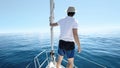 Man standing at the bow of a ship. Yachting, vacation and freedom concept Royalty Free Stock Photo