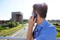 Man standing on the bridge and talking on mobile phone Royalty Free Stock Photo