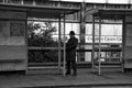 Man standing at a bus stop. Royalty Free Stock Photo