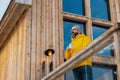 Man standing on cabins patio, drinking hot tea, coffee and enjoying beautiful winter day. Handsome man spending relaxing Royalty Free Stock Photo