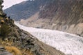 A man standing on the cliff looking at the Passu glacier. Royalty Free Stock Photo