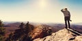 Man standing on a cliffs edge overlooking the mountains below Royalty Free Stock Photo