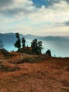Man standing on the cliffs far Mysty mountain Royalty Free Stock Photo