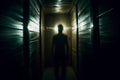 a man is standing in a dark hallway at night Royalty Free Stock Photo