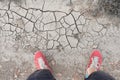 Man standing on dry cracked soil