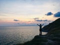 Man standing on the edge cliff and looking the sea Royalty Free Stock Photo