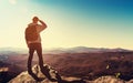 Man standing at the edge of a cliff overlooking the mountains Royalty Free Stock Photo