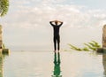A man standing at the edge of infinity pool Royalty Free Stock Photo
