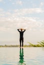 A man standing at the edge of infinity pool Royalty Free Stock Photo