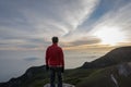 A man standing and enjoying sunrise on the rock at the top of Gede Pangrango Mountain Royalty Free Stock Photo