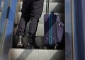 Man standing on escalator with bag Royalty Free Stock Photo