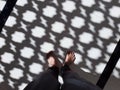 A man standing on the floor with abstract shadow from the arabic style wall in background Royalty Free Stock Photo