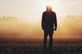 Man standing in the fog at sunrise Royalty Free Stock Photo