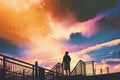 Man standing on footbridge against colorful sky Royalty Free Stock Photo