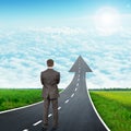 Man standing on freeway road going up as an arrow