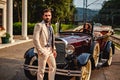 Man standing in fron of a woman in a classic car Royalty Free Stock Photo