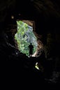 Man standing in front of a cave entrance Royalty Free Stock Photo