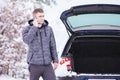 Man standing in front of damaged car and calling car services to Royalty Free Stock Photo