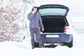 Man standing in front of damaged car and calling car services to Royalty Free Stock Photo