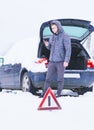 Man standing in front of damaged car and calling car services to Royalty Free Stock Photo