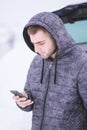 Man standing in front of damaged car and calling car services to Royalty Free Stock Photo