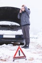 Man holding mobile phone and calling winter car services to help Royalty Free Stock Photo