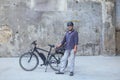 man standing in front of electric bicycle