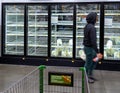 Man Standing in Front of Empty Dairy Case During COVID-19 Pandemic