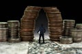 Man standing in front of giant coin pile, business concept