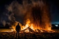 Man standing in front of a Guy Fawkes bonfire Generated AI Royalty Free Stock Photo