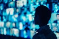 A man standing in front of a large television screen indoors, Abstract representation of teleconferencing as a modern form of Royalty Free Stock Photo