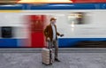 Man standing in front of moving train on station Royalty Free Stock Photo