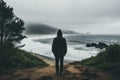 Man standing in front of the ocean and looking at the stormy sea - Generative AI Royalty Free Stock Photo