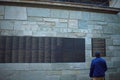 Man standing in front of the Shoah Holocaust Memorial to Jews in Paris France