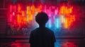 Man standing in front of vibrant graffiti wall under neon lights Royalty Free Stock Photo