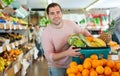 Man standing with full grocery cart during shopping in fruit shop Royalty Free Stock Photo