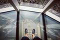 Man standing on a glass floor at Lotte Tower observation deck