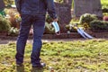 Man standing at the grave of family members with a facemask during the pandemic