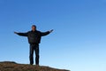 A man standing high up on a mountain