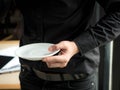 Man standing holding a coffee saucer